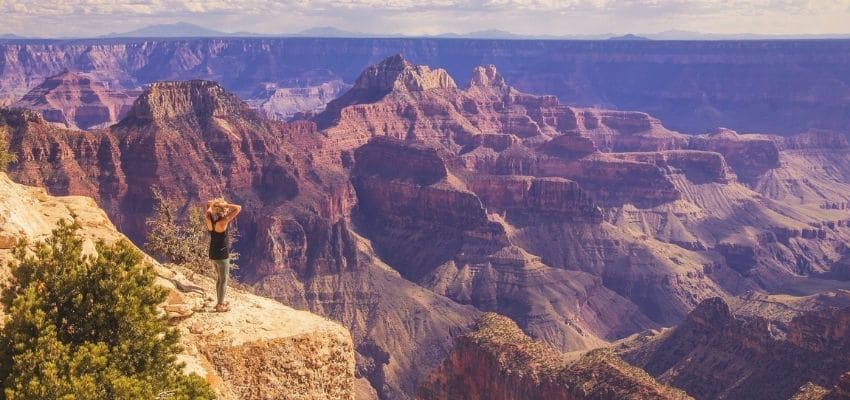 woman staring at grand canyon in awe